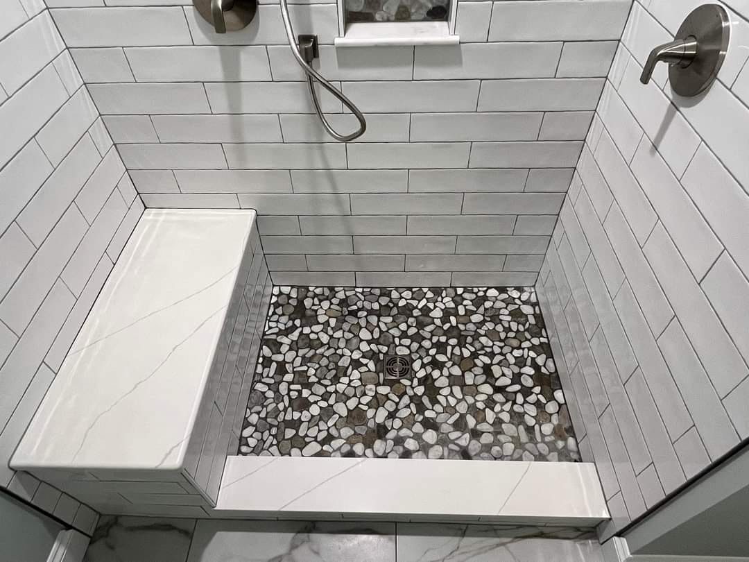 Walk-in shower with white subway tile and pebble floor, Calgary bathroom renovation