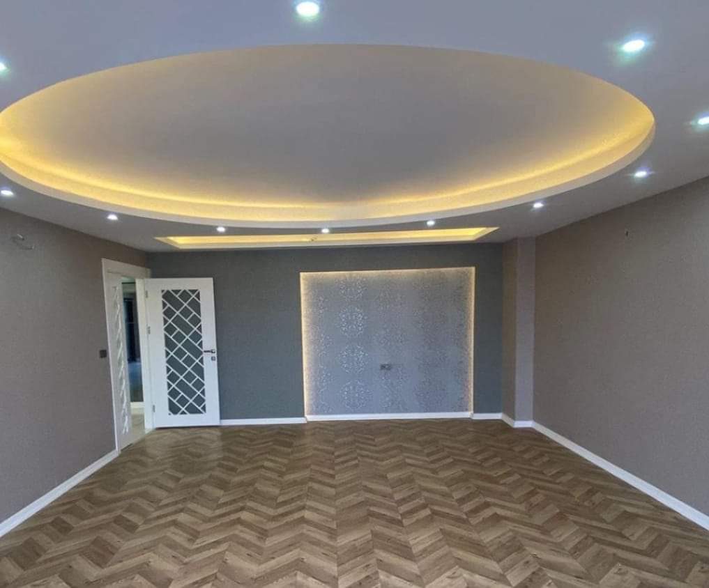 Oval cove ceiling with warm LED lighting in Calgary living room