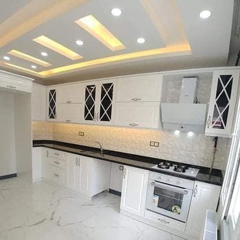 Modern kitchen with black countertops and glass cabinet doors, Calgary